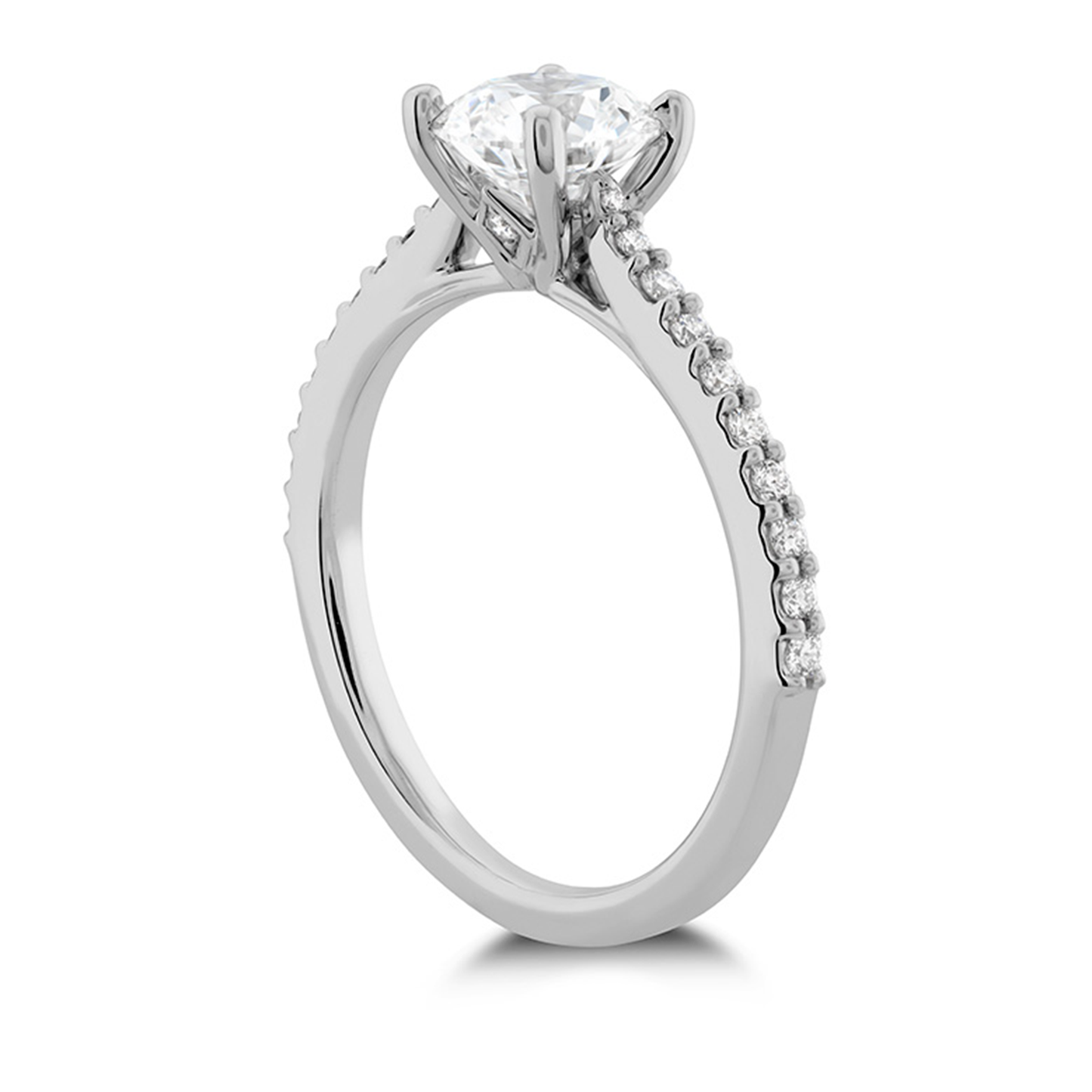 The elegant Hearts On Fire Camilla 18K White Gold Semi Mount Solitaire Engagement Ring highlights a central round diamond surrounded by small diamonds along the band, showcasing its exquisite design that ensures the gemstone stands out prominently from a side view.