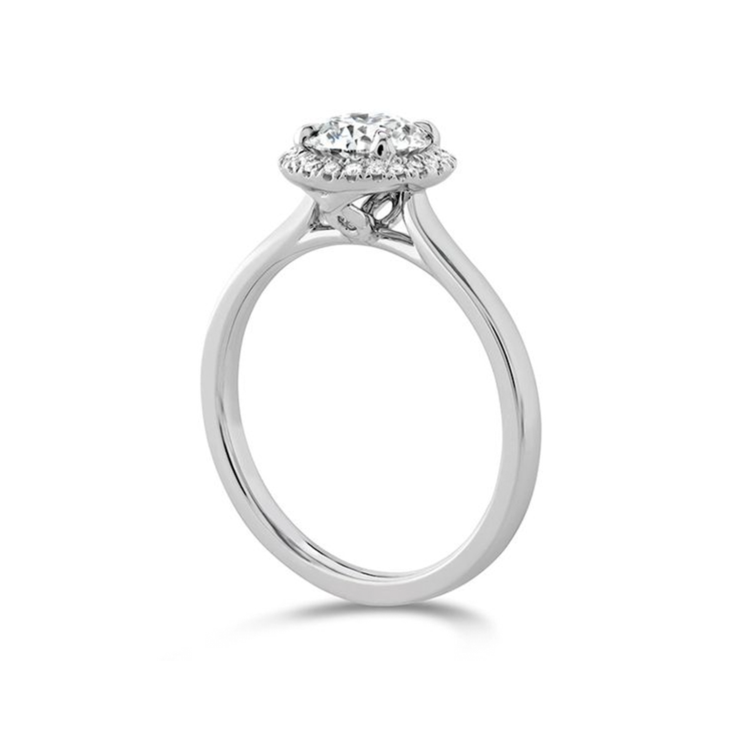 The Hearts On Fire 18K White Gold Round Brilliant Diamond Halo Engagement Ring from Hearts on Fire showcases a stunning round-cut diamond center, elegantly surrounded by a halo of smaller diamonds. The band includes a sleek and polished finish.