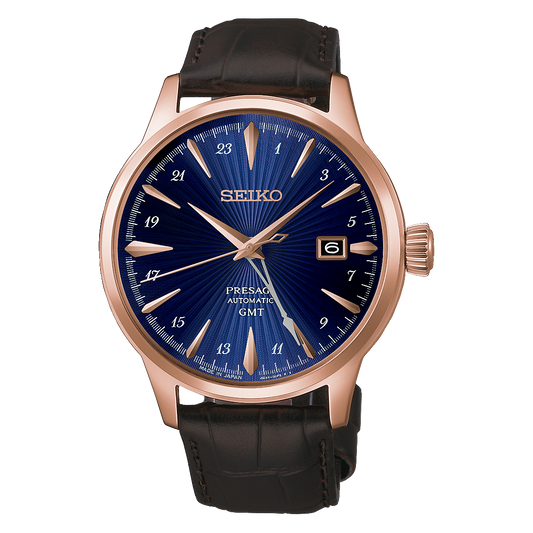 Seiko Presage Cocktail Time GMT Automatic With Manual Winding 40.5mm watch in rose-gold-tone stainless steel with a blue sunray dial, 24-hour markers, a date window, and a dark brown leather strap.