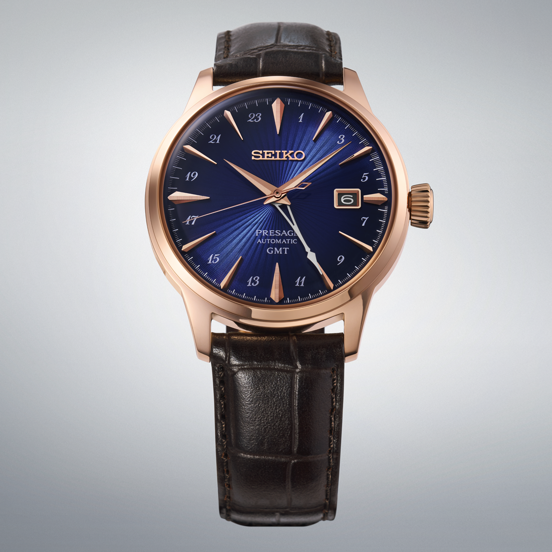 Seiko Presage Cocktail Time GMT Automatic With Manual Winding 40.5mm watch featuring a blue sunray dial, rose-gold-tone stainless steel case, and dark brown leather strap.