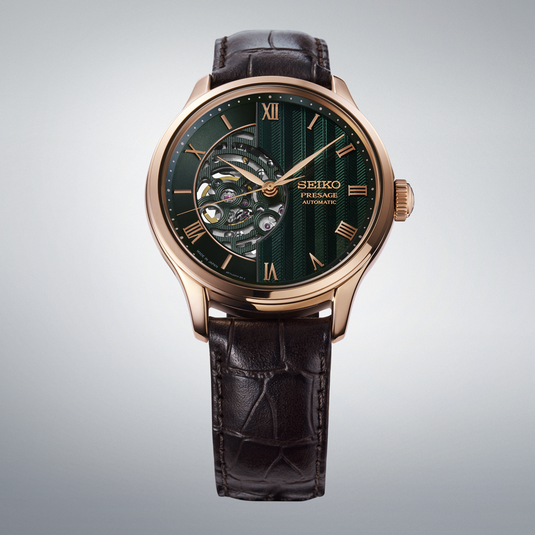 Seiko Presage Japanese Garden Open Heart Automatic With Manual Winding 41.8mm Watch featuring a rose gold case, dark green dial with open heart movement, and a brown leather strap.