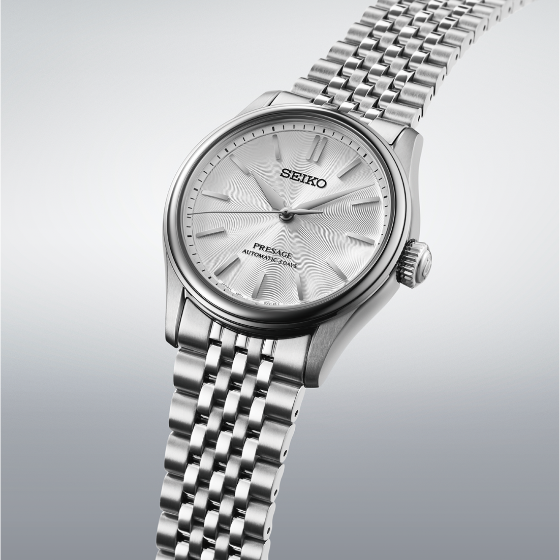Seiko Presage Classic Series Automatic With Manual Winding 38mm Watch featuring a silver textured dial, silver hands, and a multi-link metal bracelet.