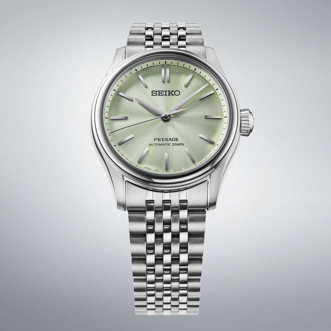 A silver-tone Seiko Presage Classic Series Automatic With Manual Winding 38mm Watch featuring a metallic green patterned dial and a multi-link steel bracelet.