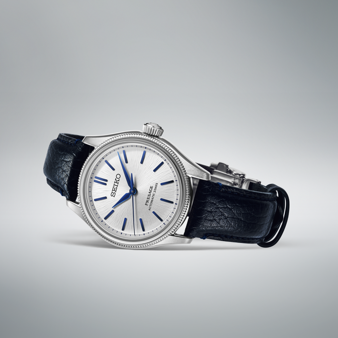 A Seiko Presage Classic Series 145th Anniversary Limited Edition Automatic With Manual Winding 36mm Watch featuring a stainless steel case, silver textured dial, blue indices and hands, and a black leather strap.