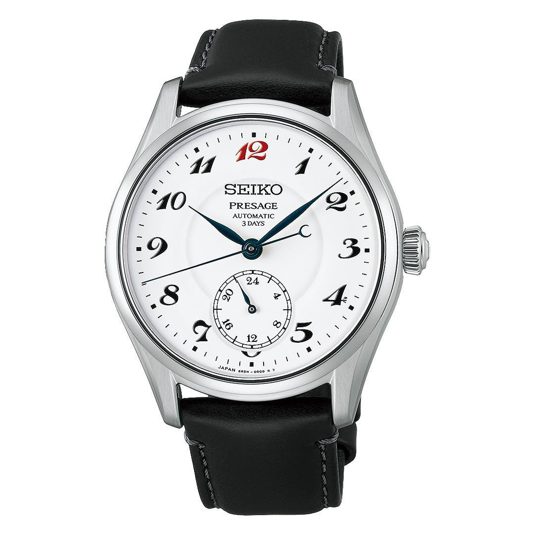 The Seiko Presage Classic Series Automatic 39.6mm Watch by Seiko features a refined silver case, a white dial with black hands, Arabic numerals, and a striking red number 12. A subdial is positioned at 6 o’clock, complemented by a sophisticated black leather strap—an automatic wristwatch that truly exemplifies timeless elegance.