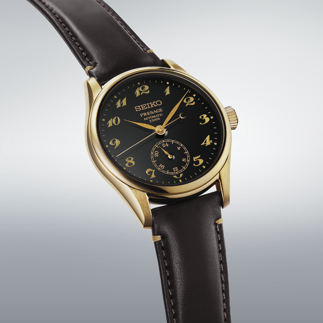 Seiko Presage Classic Series Automatic With Manual Winding 39.6mm watch in gold-tone featuring a black Urushi lacquer dial, gold numerals, and a dark leather strap.