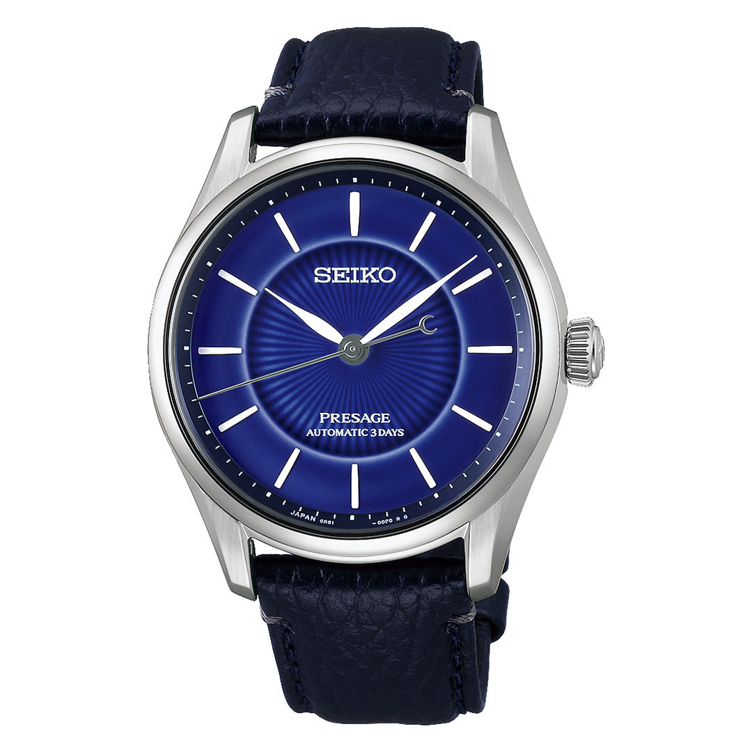 Celebrating Seiko’s 145th anniversary, the Seiko Presage Classic Series Automatic 39.6mm Watch is a limited edition of 1,500 pieces. It features a striking deep blue sunburst dial, silver hour markers, and a coordinated blue leather strap. The refined stainless steel case elegantly frames the dial, with “Presage Automatic 3 Days” displayed above the 6 o’clock position.