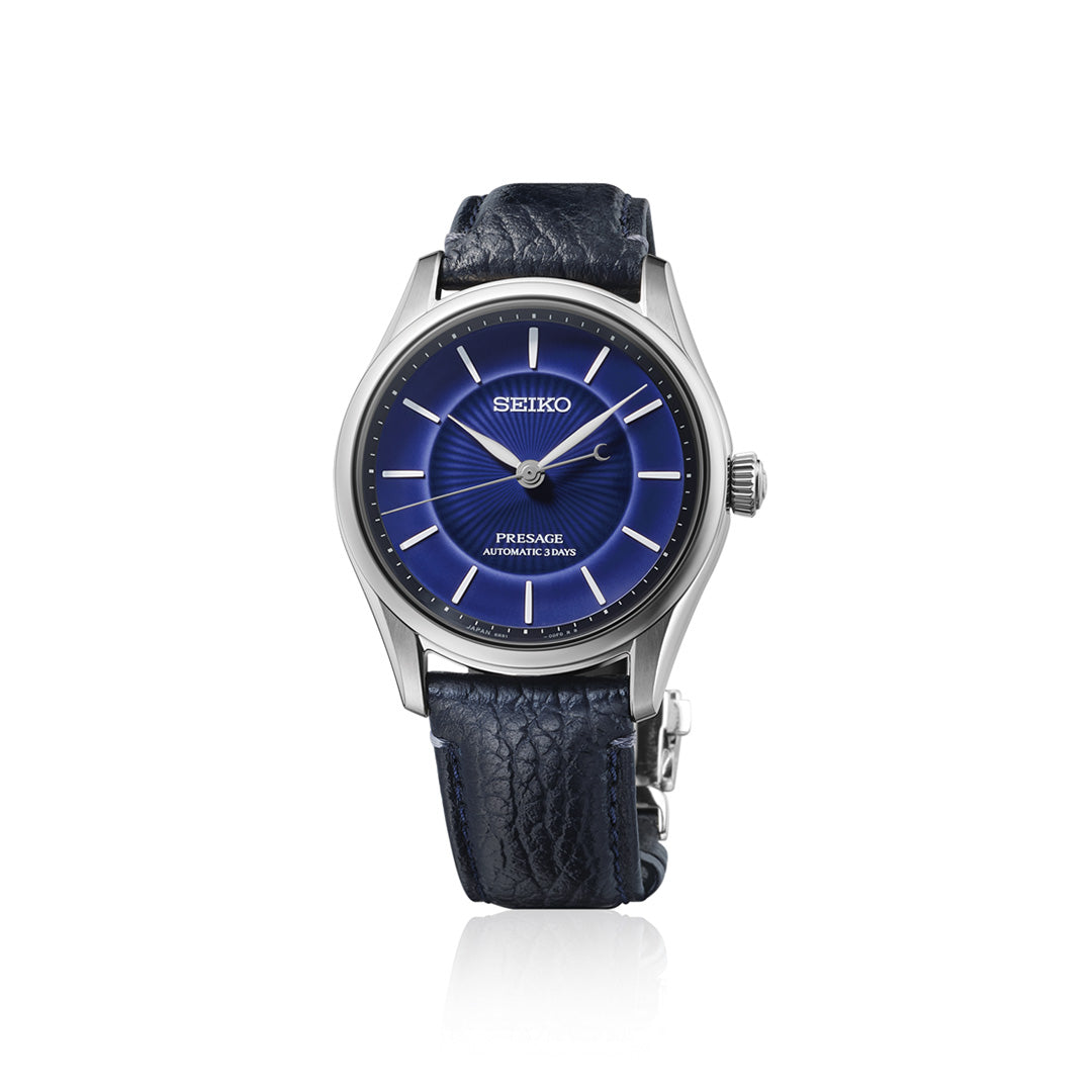 The Seiko Presage Classic Series 145th Anniversary Automatic 39.6mm Watch Limited Edition of 1,500 Pieces features a striking blue dial with silver indices and a textured dark blue leather strap, presented on a white background. This refined timepiece from Seiko exemplifies the brand’s exceptional craftsmanship and timeless elegance.