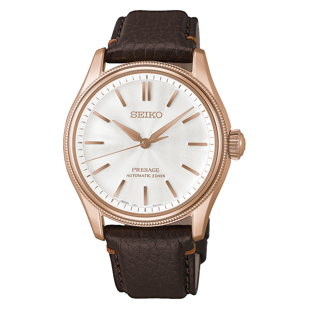 Introducing the Seiko Presage Classic Series Tomioka Silk Promotion Organization Automatic 38mm Watch, a limited edition of 2,000 pieces, featuring a rose gold case, a white textured dial with gold-tone hands and markers, and a dark brown leather strap.