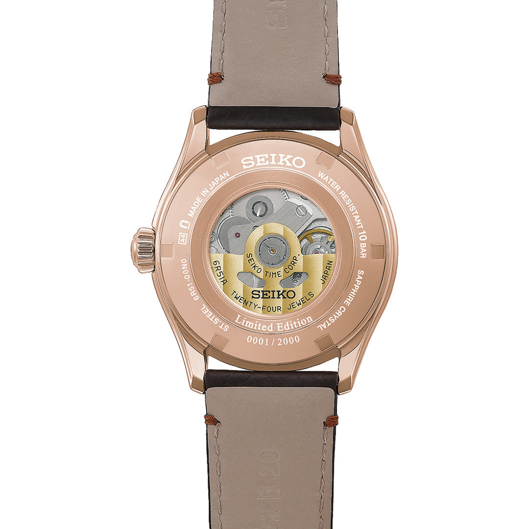 Back view of the Seiko Presage Classic Series Tomioka Silk Promotion Organization Automatic 38mm Watch, a limited edition of 2,000 pieces, showcasing its intricate movement through a transparent case back, engraved unique serial number, and elegant brown leather strap in a refined design.