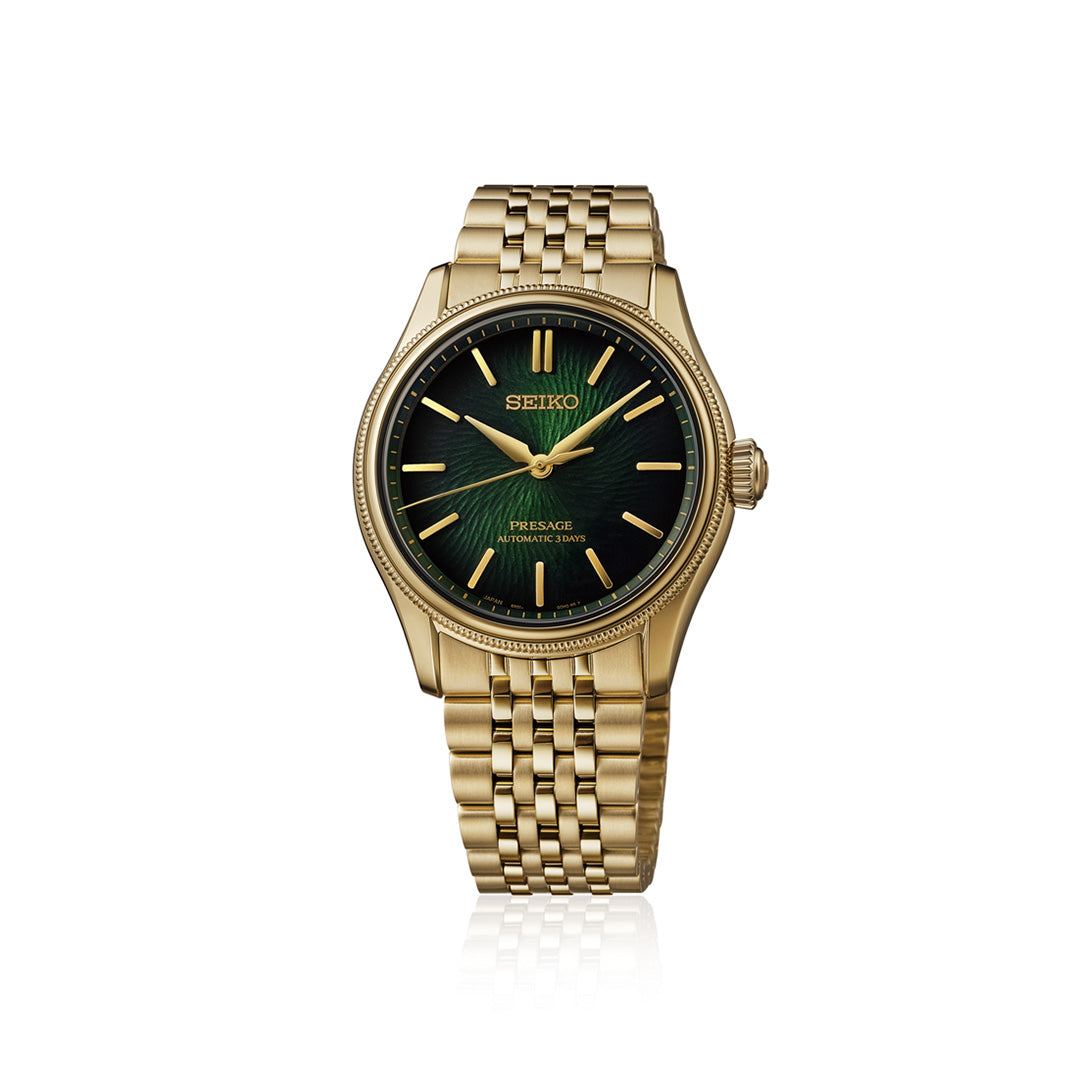 The Seiko Presage Classic Series Tradman’s Bonsai Automatic 38mm Watch is a limited edition timepiece—one of only 2,000 pieces made. Featuring a gold case, green dial, gold hour markers, and a metal link bracelet, this refined wristwatch by Seiko is showcased on a white background and exemplifies timeless elegance with modern craftsmanship.