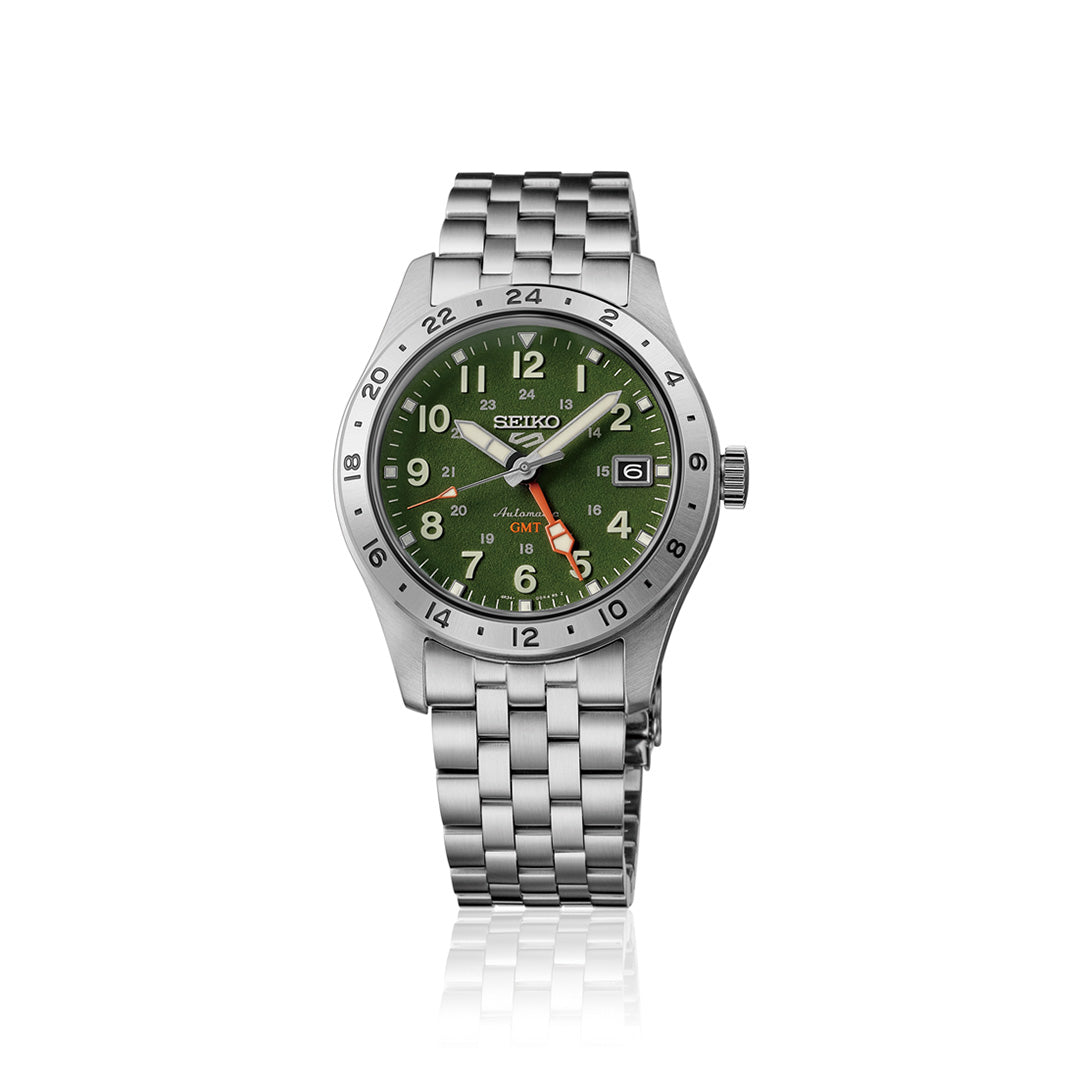 The Seiko 5 Sports Field Series GMT Automatic 39.3mm Watch by Seiko showcases a stainless steel bracelet, a vibrant green dial, and a silver bezel accented by an orange GMT hand. The date is conveniently located at the 3 o’clock position, and the watch’s crisp design against a white background offers a perfect balance of style and practicality.
