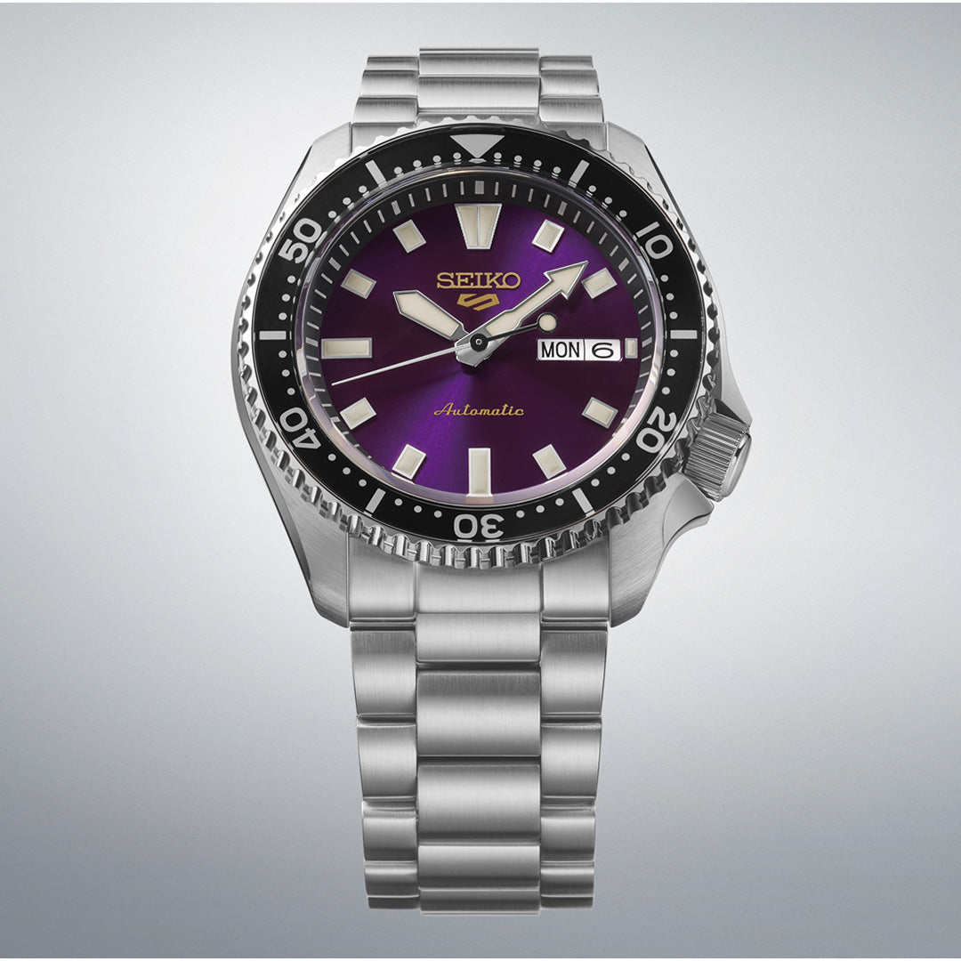 A Seiko 5 Sports SKX Series Limited Edition Automatic 42.5mm watch with a stainless steel band, black bezel, and a purple dial displaying the time as 10:08. The day and date window shows “MON 6”.