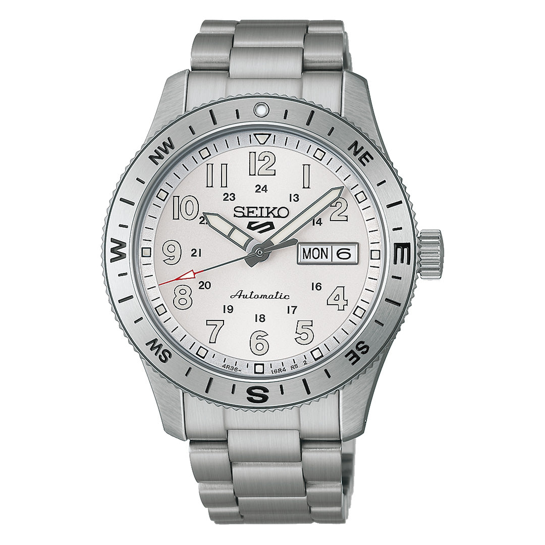 A Seiko 5 Sports Field Series Automatic 41mm Watch by Seiko featuring a silver-tone metal bracelet, white dial, day-date display, and compass markings on the bezel. The hour, minute, and second hands are equipped with LumiBrite for enhanced visibility in low light conditions.