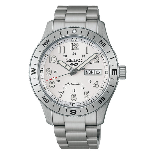 A Seiko 5 Sports Field Series Automatic 41mm Watch by Seiko featuring a silver-tone metal bracelet, white dial, day-date display, and compass markings on the bezel. The hour, minute, and second hands are equipped with LumiBrite for enhanced visibility in low light conditions.