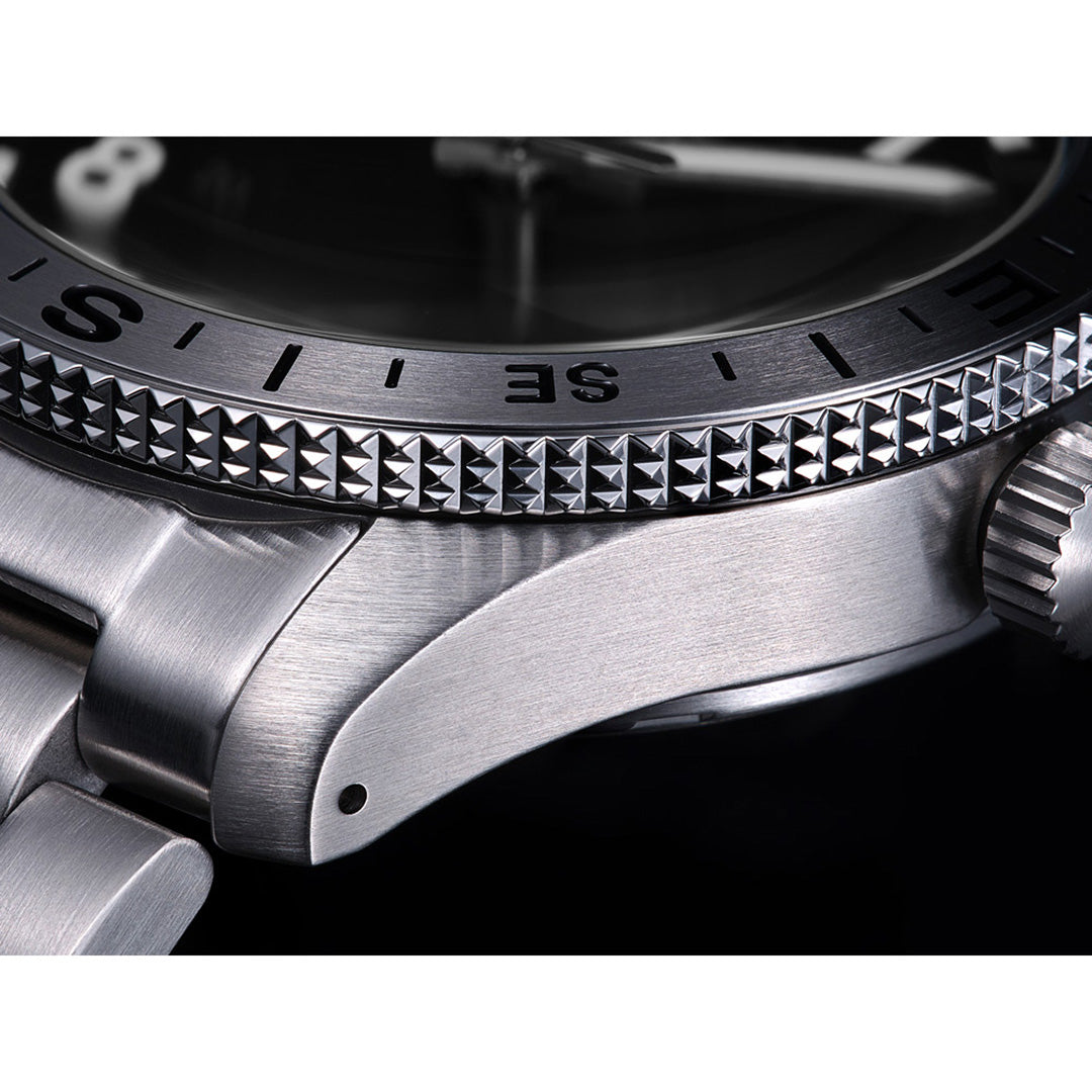 Close-up of the Seiko 5 Sports Field Series Automatic 41mm Watch by Seiko, highlighting the intricately textured bezel and a portion of the stainless steel bracelet. The watch displays a brushed metal finish and features LumiBrite accents for improved visibility.