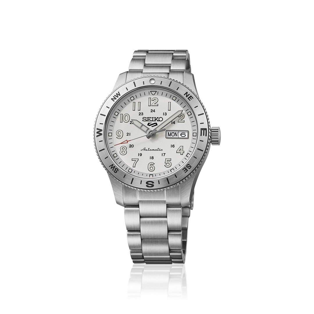 The Seiko 5 Sports Field Series Automatic 41mm Watch by Seiko features a robust stainless steel bracelet, a white dial with black numerals, LumiBrite hands for enhanced visibility, a day and date display, and compass markings (N, E, S, W) on the bezel.