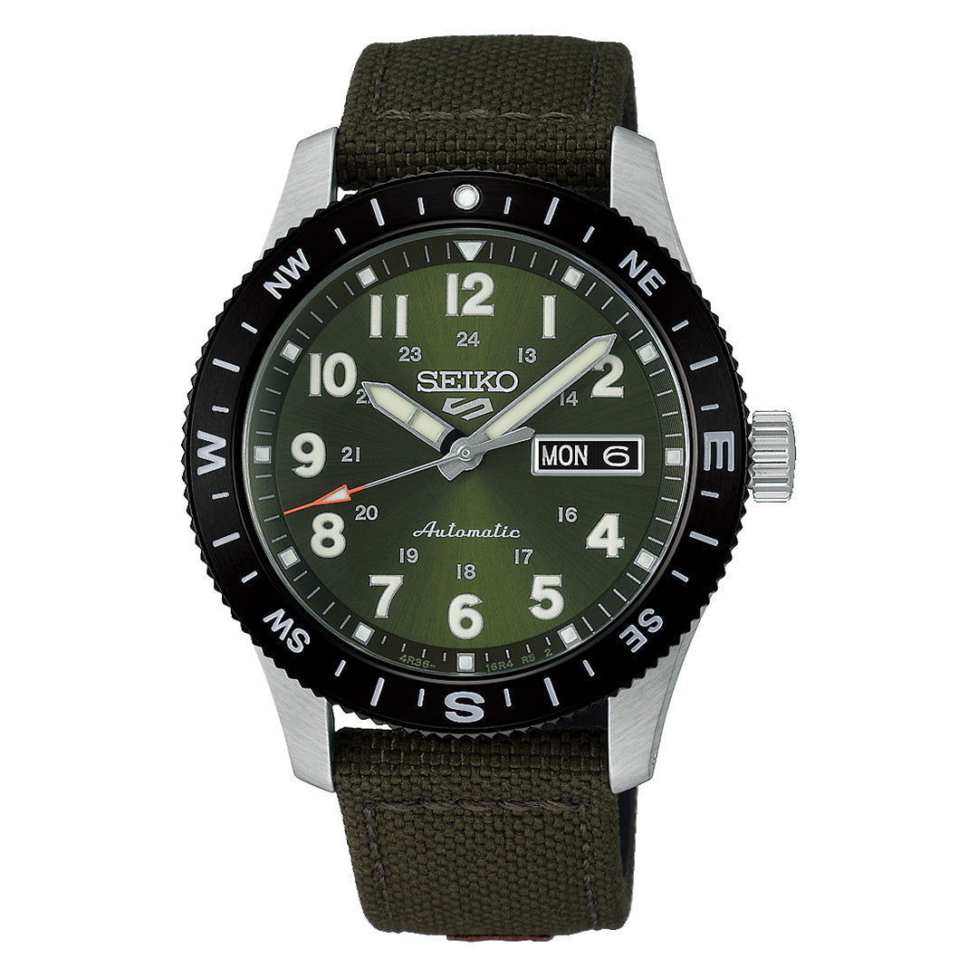The Seiko 5 Sports Field Series Automatic 41mm Watch by Seiko features an olive green dial, a black compass-marked bezel, bold white LumiBrite numerals for improved visibility, and a practical day-date display. Its robust design is complemented by a rugged nylon strap and a silver-toned case.