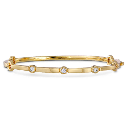 The Hearts On Fire Copley Bangle Bracelet by Hearts on Fire is an elegant jewelry piece, featuring a sleek, modern design with five evenly spaced I/J diamonds in yellow gold.
