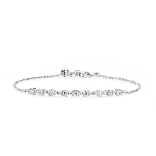 Presenting the Hearts On Fire Aerial Dewdrop 18K White Gold Diamond Bracelet, a refined piece by Hearts on Fire. This stunning bracelet is crafted from 18 Karat White Gold and adorned with a series of small round diamonds elegantly linked by a slender chain. It gleams beautifully against a white backdrop and is equipped with a clasp to ensure secure fastening.