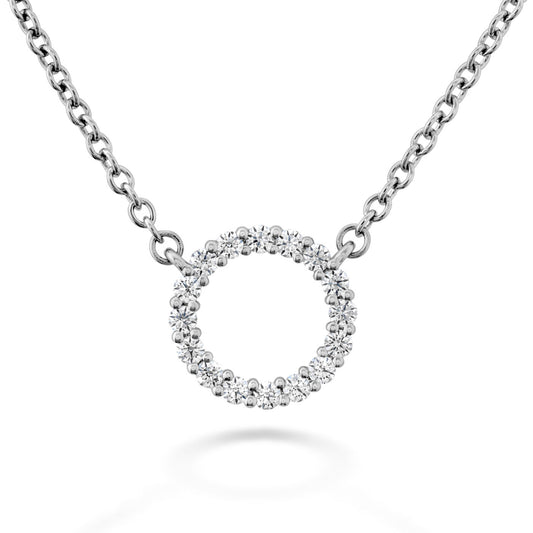 The Hearts On Fire Signature Circle 18K White Gold Pendant by Hearts on Fire features an exquisite open circle design. Crafted from 18-karat white gold and adorned with small sparkling stones, it hangs delicately on a chain, radiating elegance and sophistication.