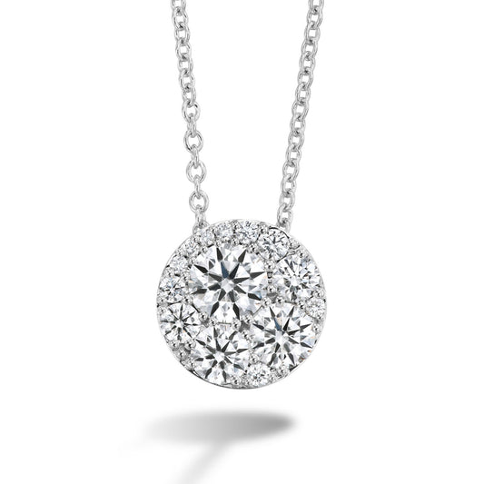 This elegant necklace showcases the Hearts On Fire Tessa 18K White Gold Pendant, featuring a cluster of round, sparkling diamonds. Arranged in a circular design on a delicate chain, the pendant casts a small shadow below, enhancing its brilliance.
