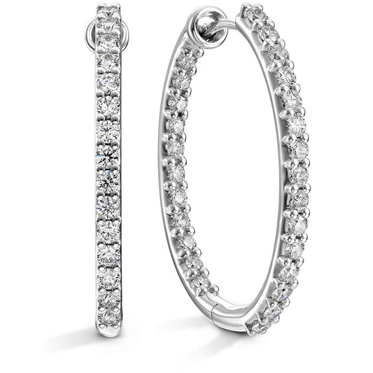 A pair of sophisticated Hearts On Fire Diamond HOF Classic Oval Inside-Out Hoop Earrings, crafted from 18 Karat White Gold and adorned with round, sparkling diamonds, presented with views from the side and front on a white background.