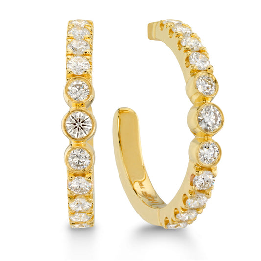 Introducing the Hearts On Fire Copley Hoop Earrings, a stunning creation from Hearts on Fire. These gold hoop earrings are beautifully adorned with round, sparkling diamonds, featuring a semi-open design and a row of diamonds encrusted along the outer edge for an elegant and luxurious appearance in yellow gold.