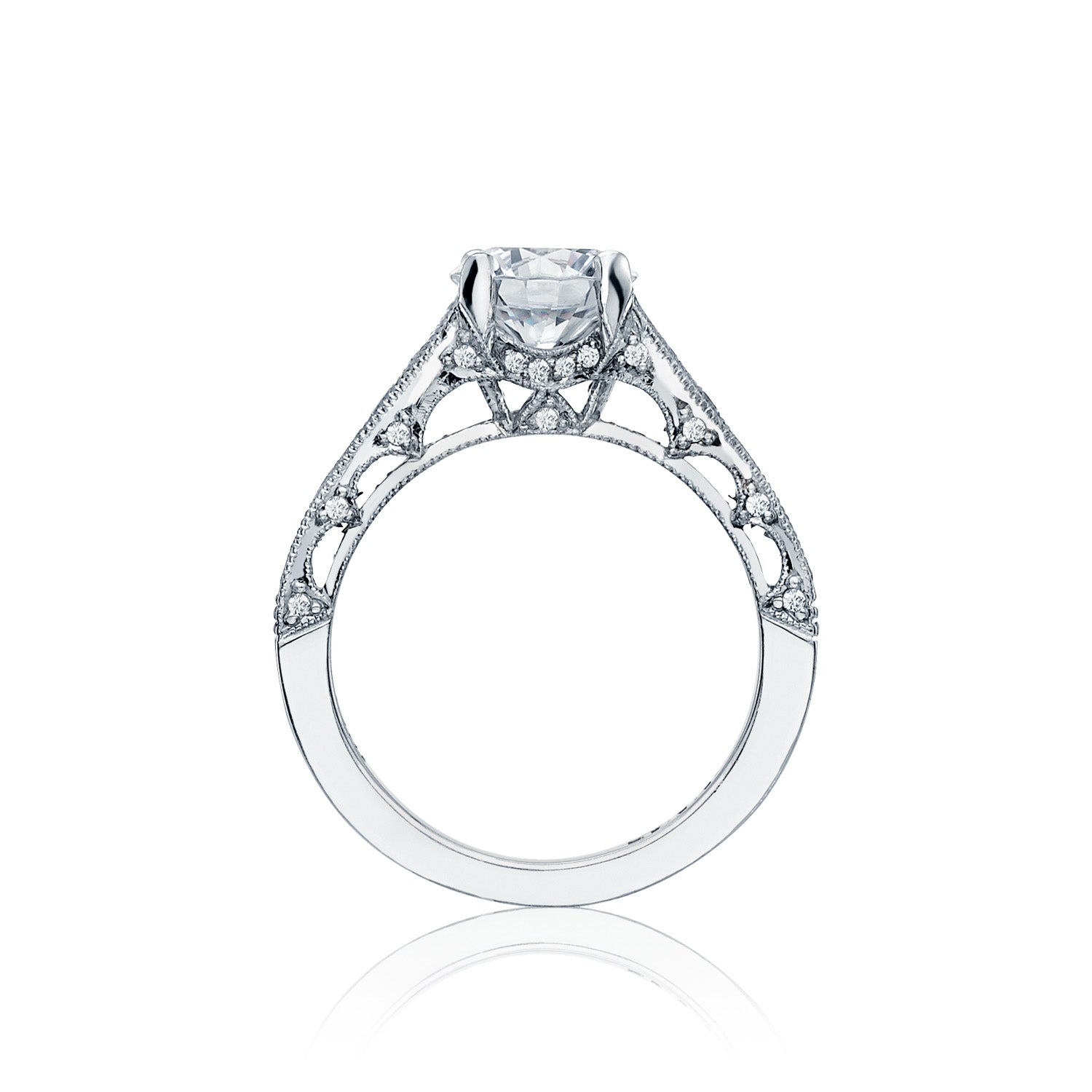 This stunning Tacori Reverse Crescent engagement ring features a prominent central diamond and an intricate filigree design on an 18K white gold band, enhanced by elegant channel set diamonds.