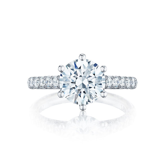 The Tacori Petite Crescent Platinum Round Brilliant Solitaire Semi Mount with Diamond Band Engagement Ring features a dazzling round-cut diamond set in a six-prong setting. Expertly crafted by Tacori gemologists, the band glimmers with smaller diamonds, enhancing its brilliance and elegance with a diamond-studded design.