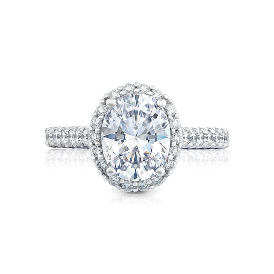 This sophisticated Tacori Petite Crescent Platinum Oval Semi Mount Engagement Ring showcases an oval center stone encircled by a radiant halo of smaller diamonds. The band, lavishly detailed with additional diamonds in the classic Petite Crescent style, accentuates its brilliance and opulent design.