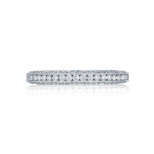 The Tacori Classic Crescent 18K White Gold Channel Set Round Brilliant Diamond Anniversary Ring showcases a row of small, round diamonds that elegantly reflect light. Displayed against a white background, its highly polished finish highlights the intricate details and sparkle—making it a perfect choice for those seeking exquisite engagement rings.