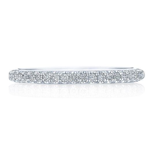 The Tacori Founder Collection 18K White Gold Round Brilliant Pavé Diamond Anniversary Ring features a stunning close-up showcasing its minimalist and elegant design. The band, adorned with French-pavé set diamonds in a continuous line, glimmers with G color VS clarity stones. The exquisite Tacori crescent signature adds a refined touch to the white background image.