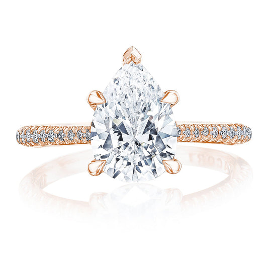 Introducing the Tacori Founders Collection 18K Rose Gold Pear Solitaire Semi Mount Engagement Ring. This exquisite piece showcases a large pear-shaped diamond at its center, complemented by a band with pavé-set diamonds that enhance its elegance and sparkle. A sophisticated claw prong detail completes the stunning setting, making it a perfect symbol of timeless beauty.