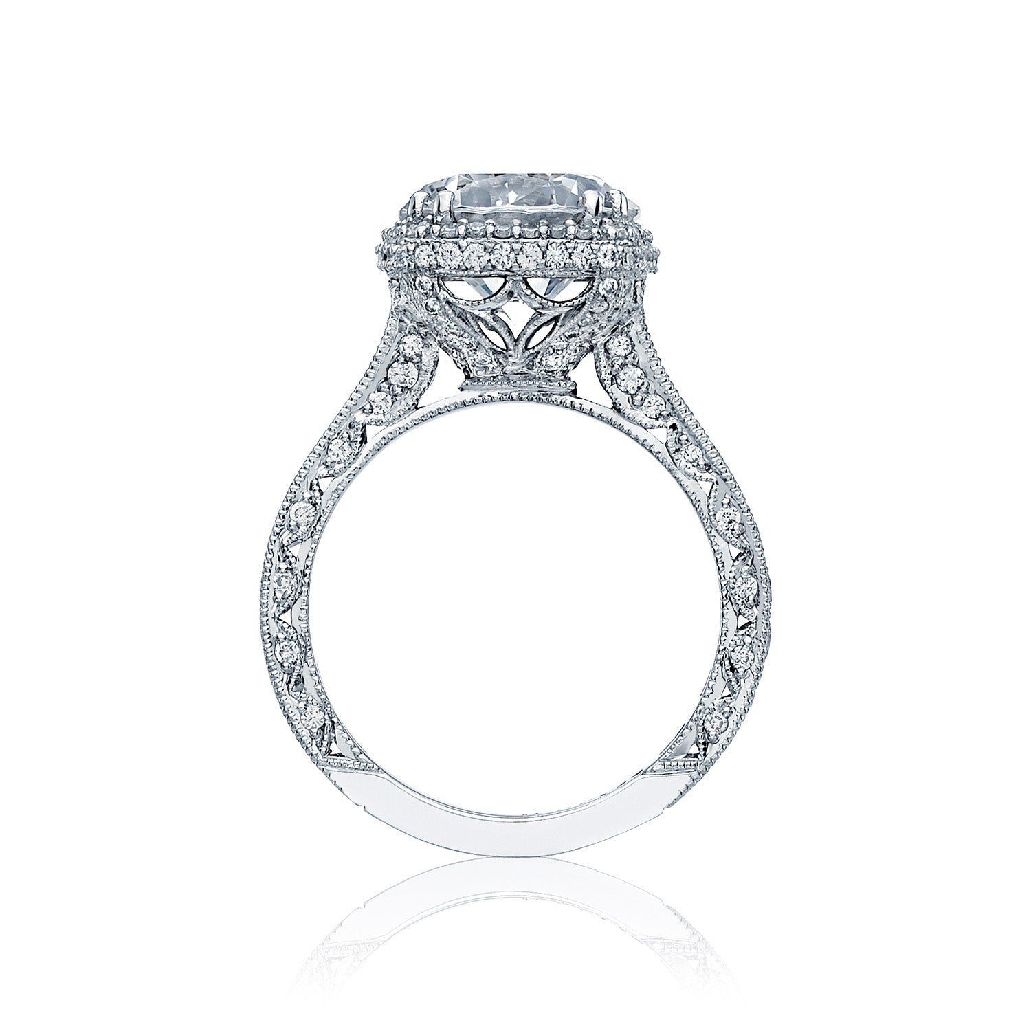 This stunning Tacori Classic Crescent RoyalT Platinum engagement ring showcases an intricate design featuring a prominent round brilliant diamond, elegantly elevated above a delicately detailed, lace-like band and accented with glimmering small diamonds.