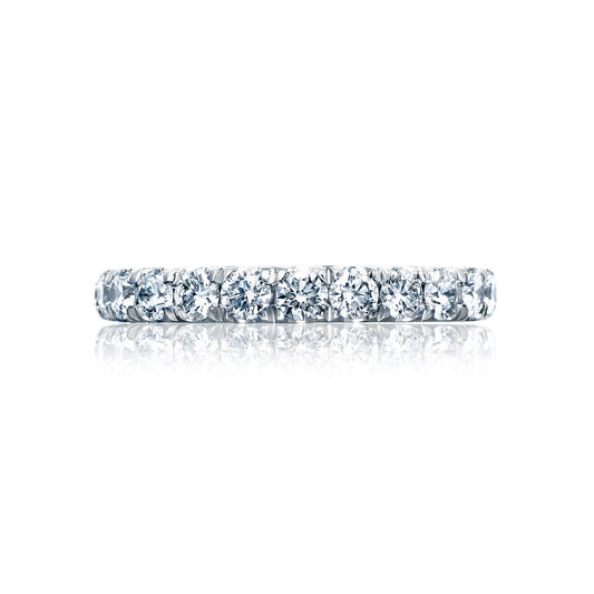 A close-up view of the exquisite Tacori Petite Crescent RoyalT Platinum Round Brilliant French Pavé Diamond Anniversary Ring showcases a stunning eternity band adorned with a continuous circle of sparkling round diamonds. The polished ring beautifully reflects light against a pristine white background.