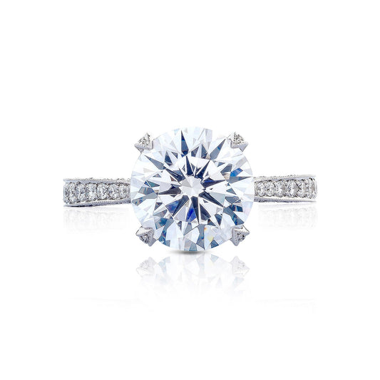 The Tacori Classic Crescent RoyalT Round Brilliant Solitaire Semi Mount with Diamond Band Engagement Ring highlights the skill of TACORI gemologists with its prominent round-brilliant diamond centerpiece set on a silver band embellished with smaller diamonds.