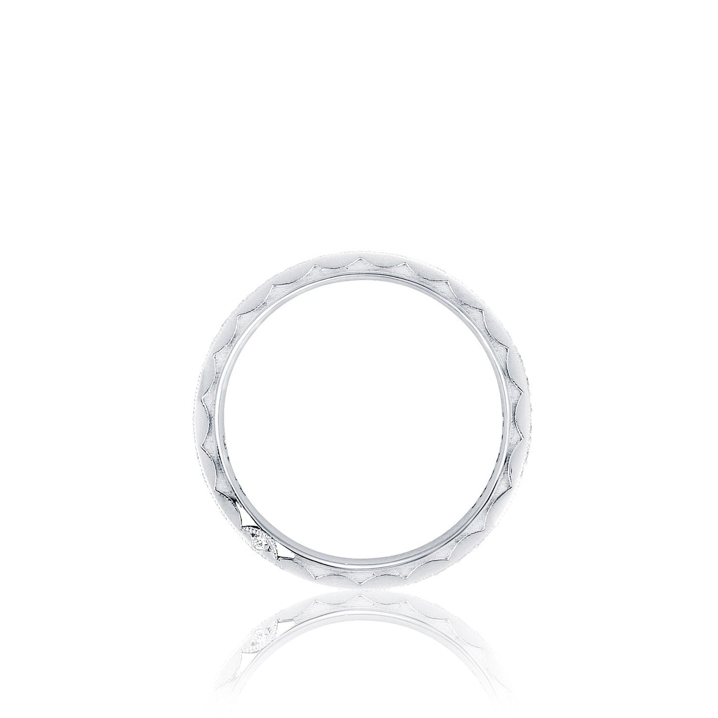 A Tacori RoyalT Sculpted Crescent platinum ring, adorned with a quilted texture and featuring round brilliant pavé diamonds, is displayed vertically against a plain white background, emphasizing its simplicity and elegance.