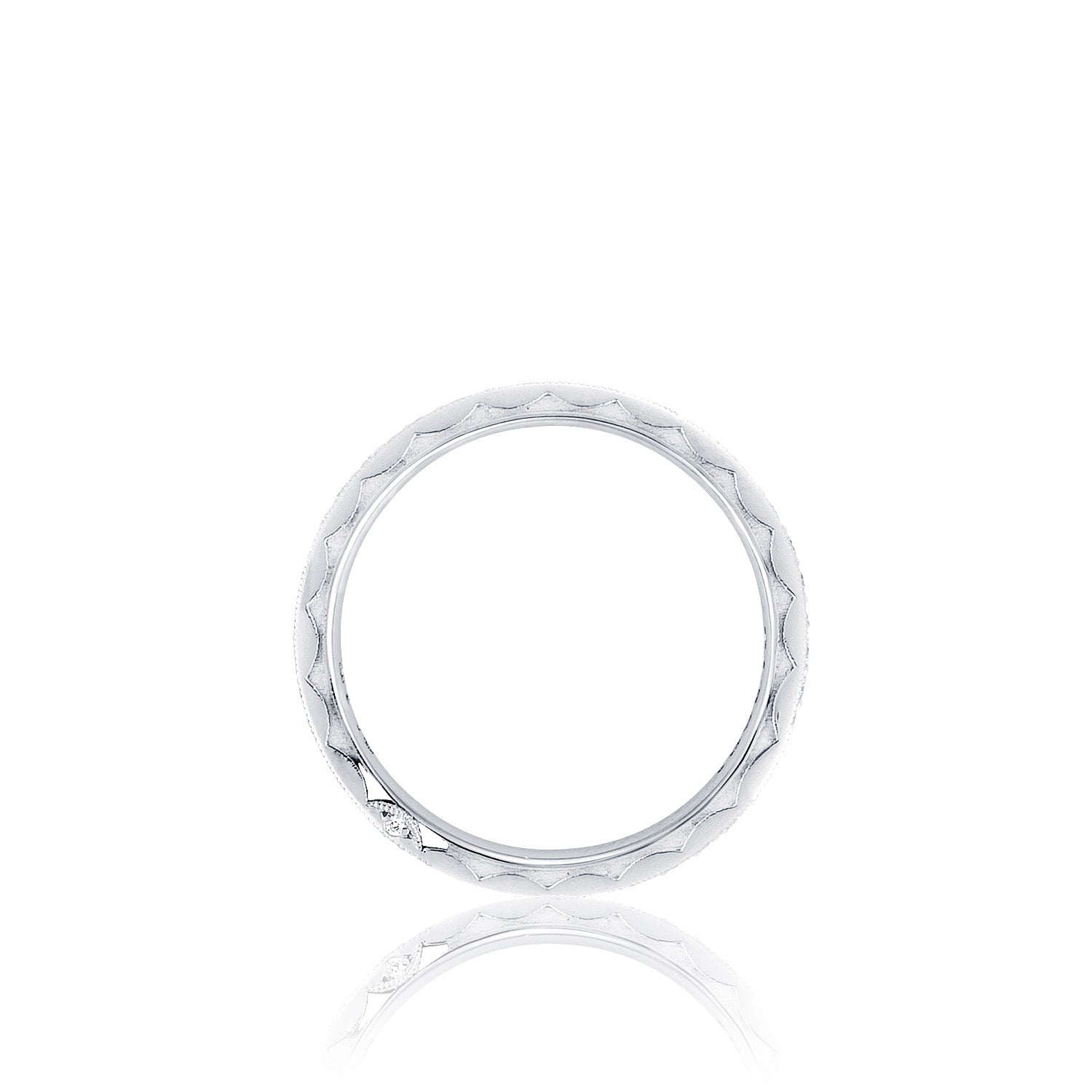 A Tacori RoyalT Sculpted Crescent platinum ring, adorned with a quilted texture and featuring round brilliant pavé diamonds, is displayed vertically against a plain white background, emphasizing its simplicity and elegance.
