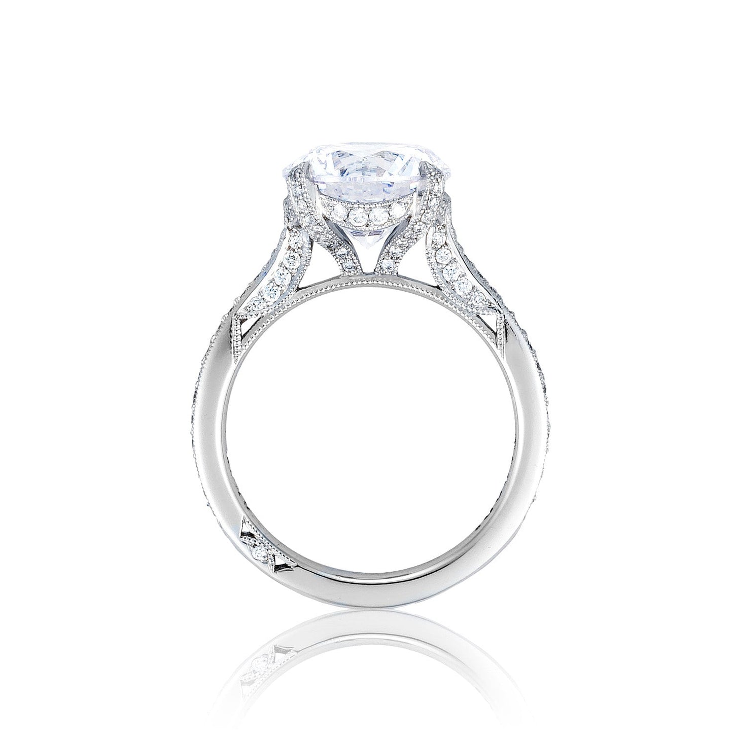 The Tacori Simply Tacori RoyalT Platinum Round Brilliant Solitaire Semi Mount Engagement Ring by Tacori highlights a magnificent solitaire with a large round diamond at its center. The band is adorned with intricate designs and smaller, sparkling diamonds along its sides, set against a plain white background.