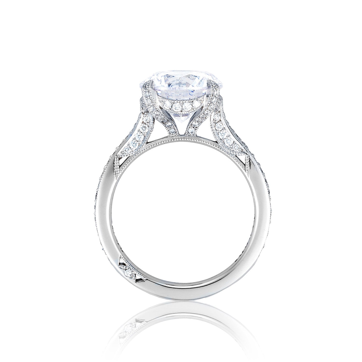 The Tacori Simply Tacori RoyalT Platinum Round Brilliant Solitaire Semi Mount Engagement Ring by Tacori highlights a magnificent solitaire with a large round diamond at its center. The band is adorned with intricate designs and smaller, sparkling diamonds along its sides, set against a plain white background.