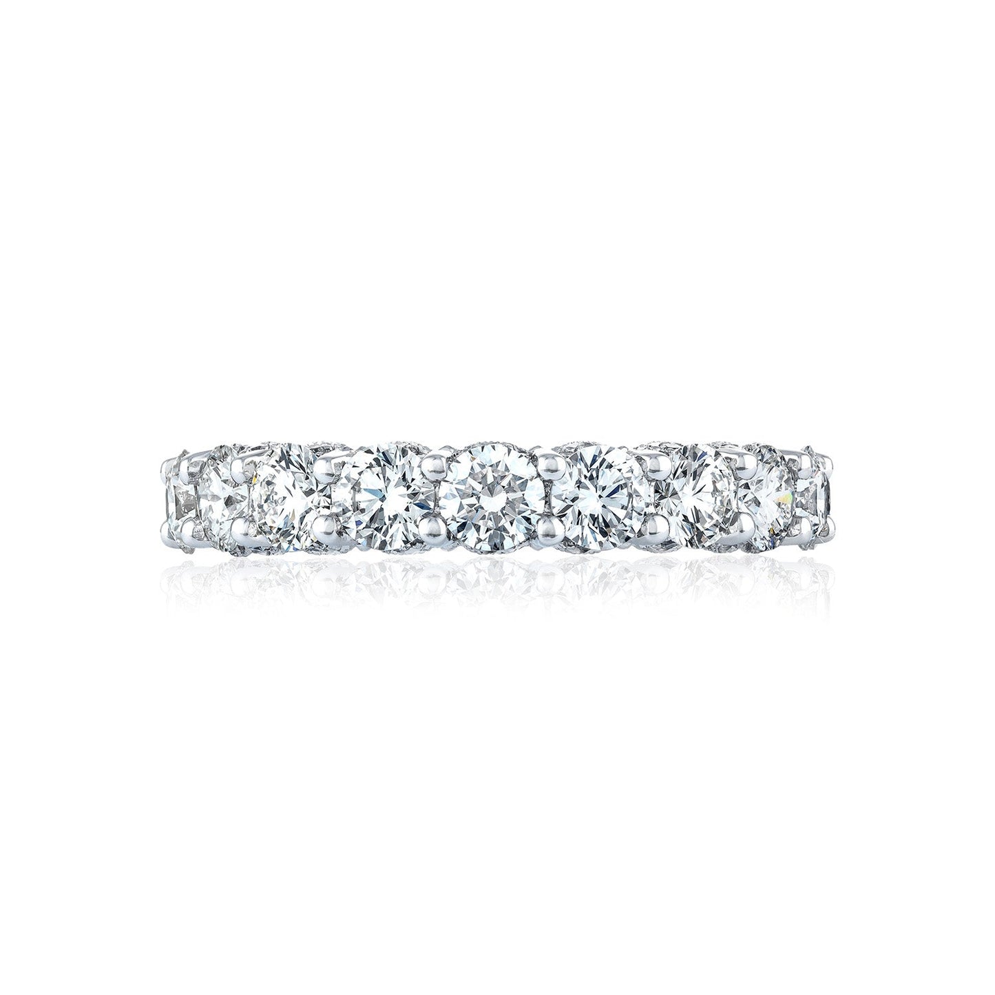 A Tacori Classic Crescent RoyalT platinum anniversary ring adorned with a row of sparkling G color round brilliant diamonds, reflecting light on a white background. The design features a continuous pattern of closely set gemstones.