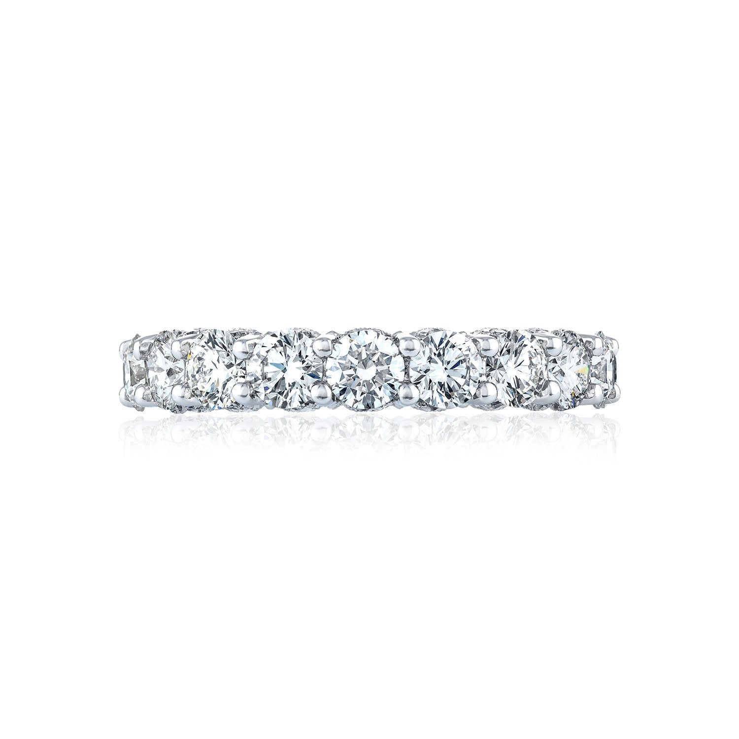 A Tacori Classic Crescent RoyalT platinum anniversary ring adorned with a row of sparkling G color round brilliant diamonds, reflecting light on a white background. The design features a continuous pattern of closely set gemstones.