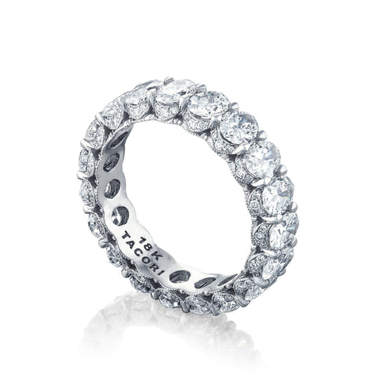 The Tacori Classic Crescent RoyalT Platinum Oval Diamond Anniversary Ring features a continuous row of round-cut diamonds set in TACORI's signature Classic Crescent design. The inner band is engraved with "18K" and "TACORI," and this exquisite ring, crafted from high-quality TACORI metal, sparkles beautifully against a white background.