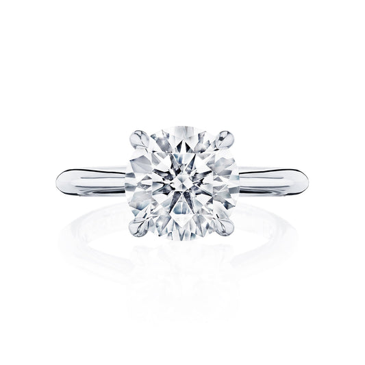This Tacori Founder's Collection RoyalT engagement ring showcases a round brilliant solitaire diamond set in an elegant platinum band. The diamond is secured by four prongs, enhancing its brilliance and clarity against the understated band.
