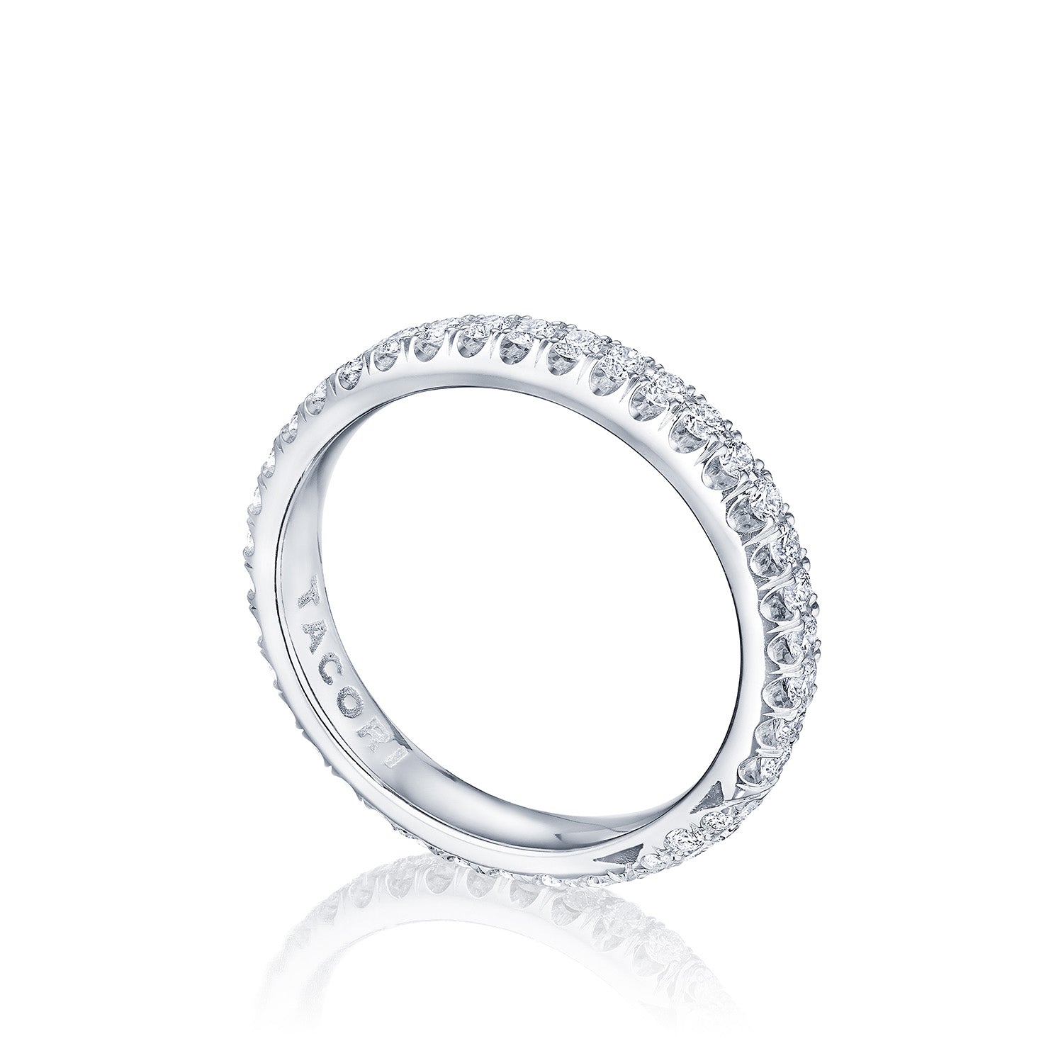 The Tacori Founder's Collection RoyalT Platinum Round Brilliant Single Row Pavé Diamond Eternity Ring features a delicate band adorned with pavé-set diamonds encircling the entire ring. Positioned at an angle, it beautifully highlights the intricate detailing and reflects on the surface below, making it a stunning choice for a wedding band.