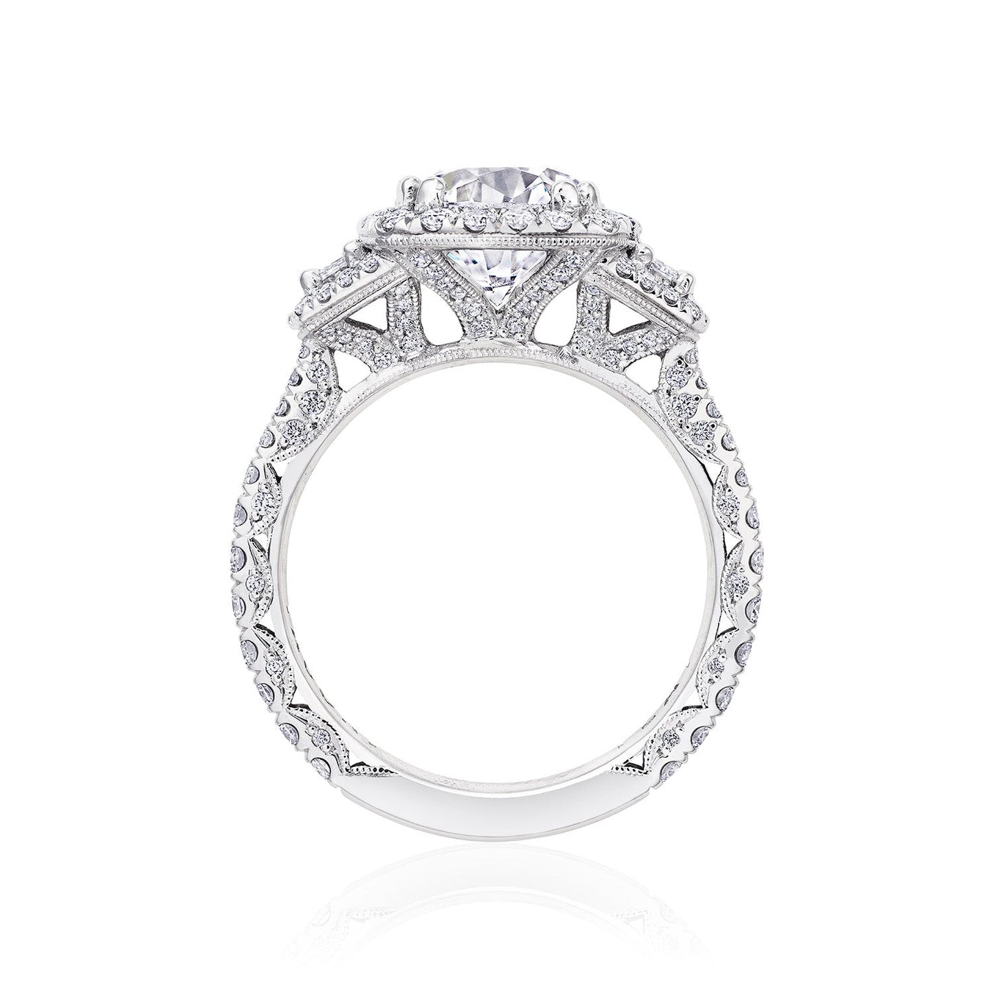 A side view of the Tacori Petite Crescent Royal T Platinum Round Brilliant Three Stone Halo Semi Mount with Diamond Side Stone Engagement Ring reveals a breathtaking central diamond, elegantly bordered by smaller diamonds in a detailed design along the band. Crafted with precision, this exquisite piece exemplifies the artistry of Tacori gemologists.