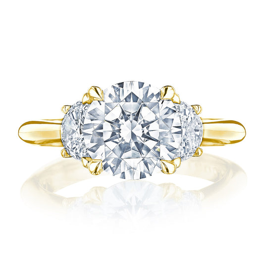The Tacori Founder's Collection RoyalT ring is a stunning 18K yellow gold three-stone semi-mount, featuring a brilliant round diamond at the center, complemented by two beautiful half-moon diamond side stones.