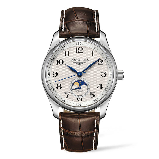 The Longines Master Collection Automatic Moonphase 40mm Watch by Longines boasts a pristine white face with Arabic numerals, complemented by blue hands and a moon phase display positioned at six o'clock. Its silver-toned case is elegantly matched with a brown leather strap, featuring white stitching, exemplifying classic watchmaking sophistication.