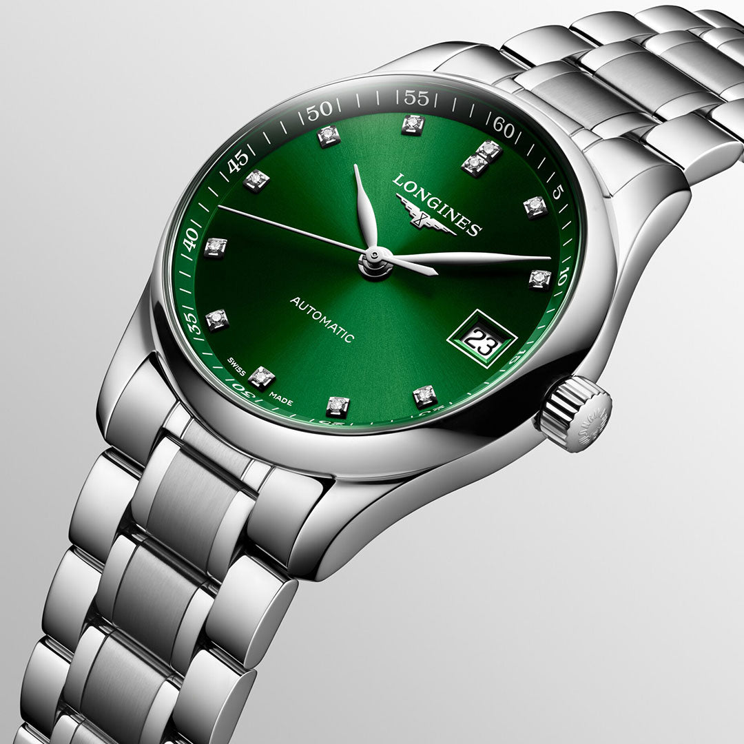 This exquisite watch from the Longines Master Collection, known as the Longines Master Collection Automatic 34mm Watch, showcases a green dial adorned with white brand lettering, diamond hour markers, and a date display at 3 o'clock. The timepiece features a gradient gray background, a silver steel link bracelet, and "Automatic" inscribed on the dial.